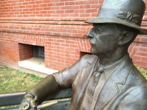 William faulkner statue on bench